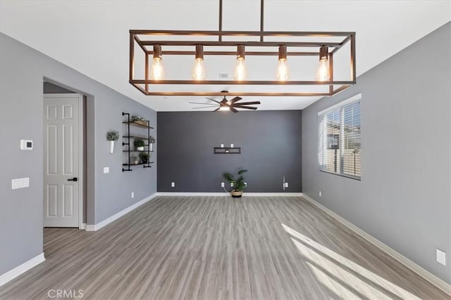 empty room with light hardwood / wood-style flooring and ceiling fan