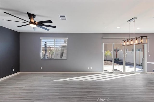 unfurnished room featuring ceiling fan and hardwood / wood-style flooring