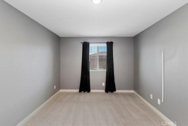 spare room with light colored carpet