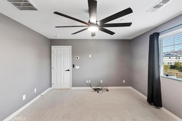 carpeted spare room with ceiling fan