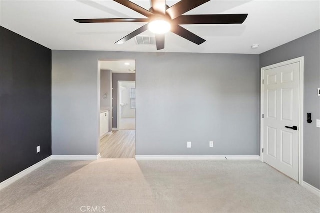 unfurnished room with ceiling fan and light colored carpet