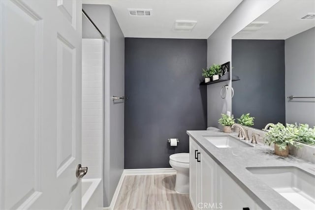 bathroom with hardwood / wood-style floors, vanity, and toilet