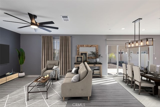 living room with hardwood / wood-style flooring and ceiling fan