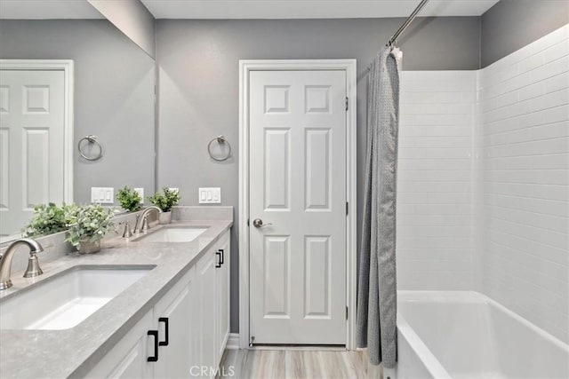 bathroom featuring vanity, hardwood / wood-style flooring, and shower / bath combo with shower curtain