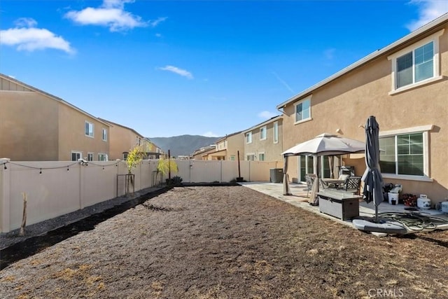 view of yard with a gazebo, a mountain view, and a patio