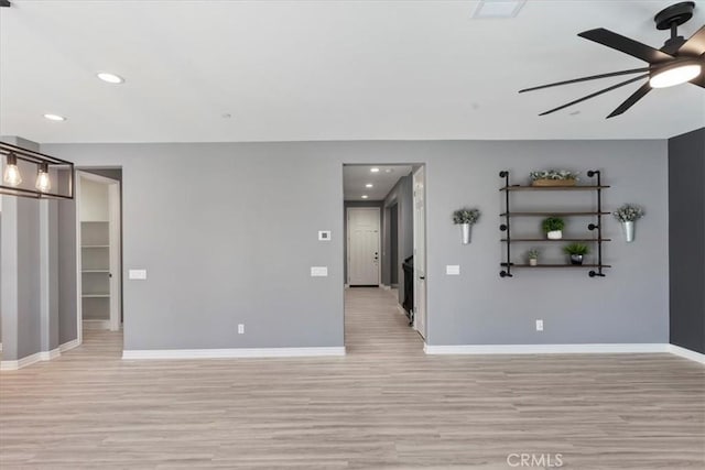 unfurnished living room with ceiling fan and light hardwood / wood-style floors