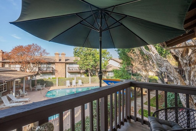 wooden terrace with a fenced in pool