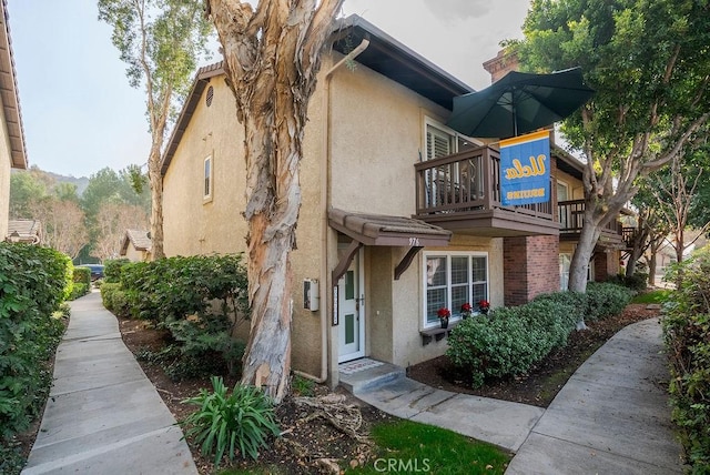 exterior space with a chimney and stucco siding