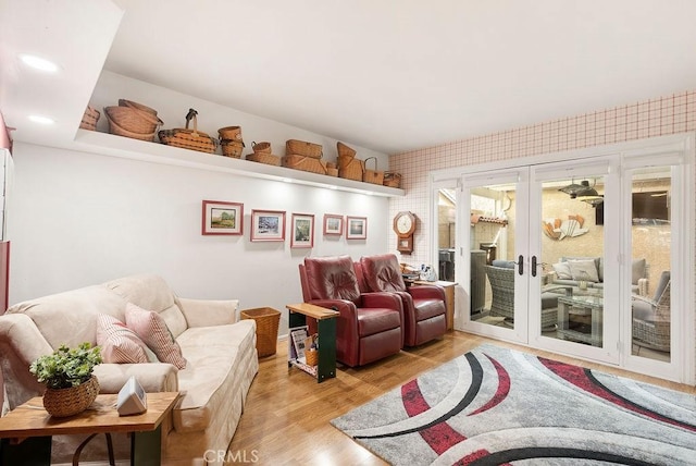 sitting room with light wood-style floors, recessed lighting, and french doors