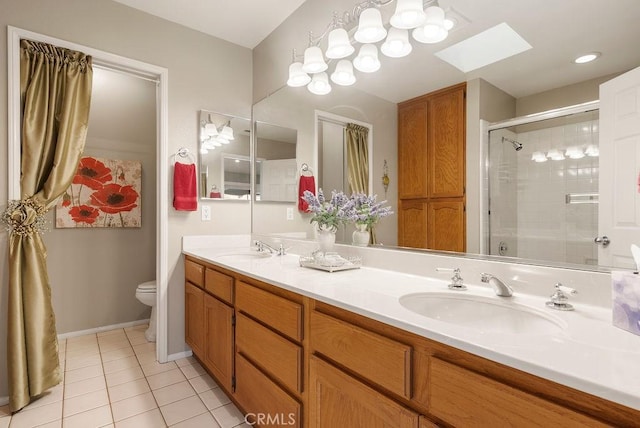 full bath with toilet, a skylight, a tile shower, and a sink