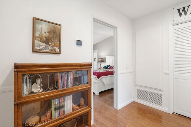 hallway with visible vents and light wood-style flooring