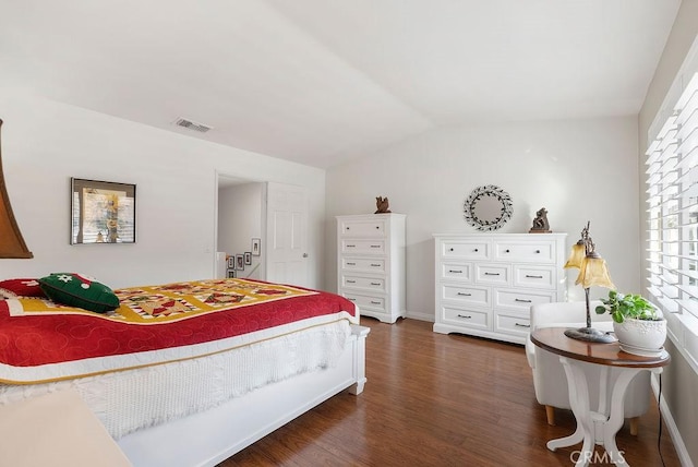 bedroom featuring lofted ceiling, dark wood finished floors, visible vents, and baseboards