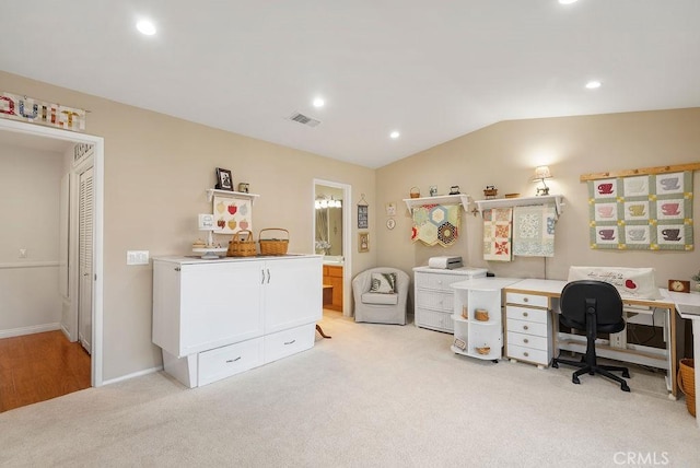 office space with recessed lighting, visible vents, vaulted ceiling, and light carpet