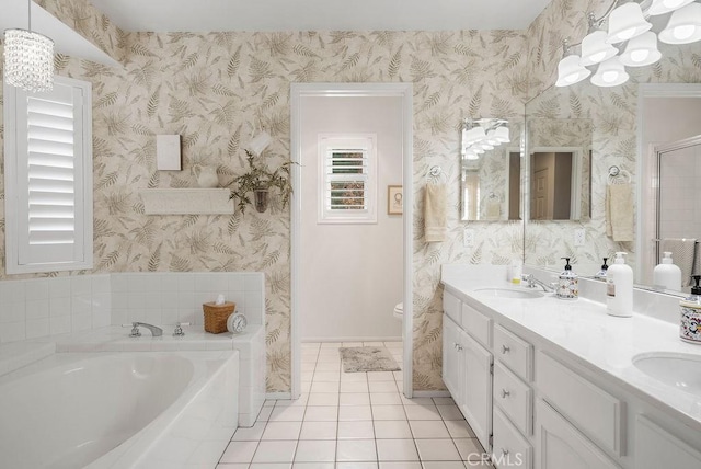 full bathroom with a sink, a bath, tile patterned floors, double vanity, and wallpapered walls