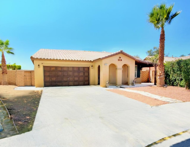 mediterranean / spanish home featuring a garage