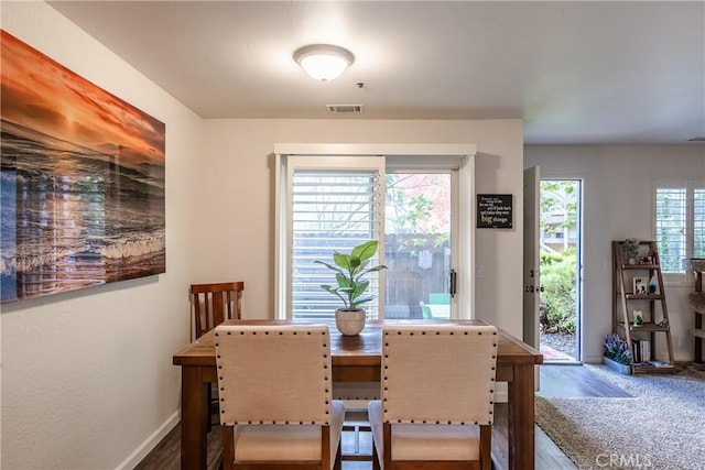 dining area with wood-type flooring