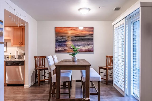 dining space with dark wood-type flooring