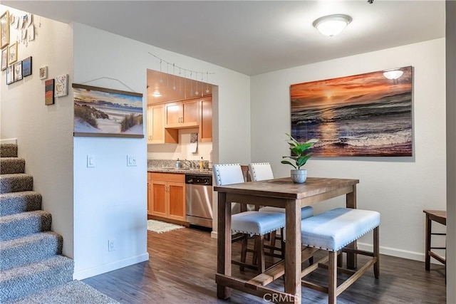 dining space featuring dark hardwood / wood-style flooring and sink