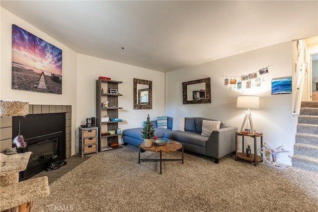 living room with a tiled fireplace and carpet