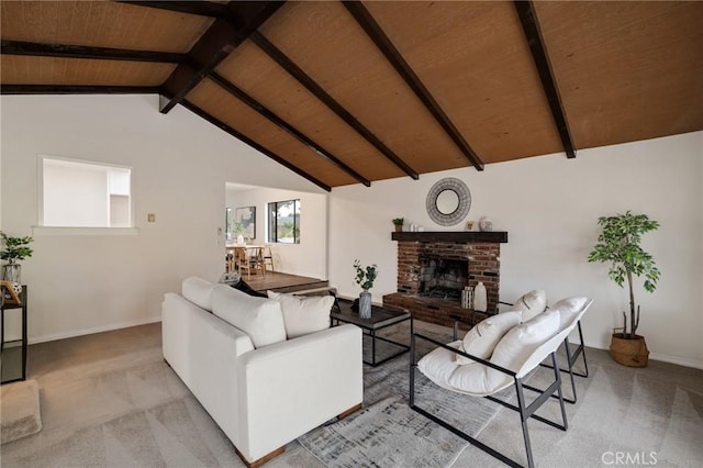 carpeted living room with vaulted ceiling with beams, a fireplace, and wooden ceiling