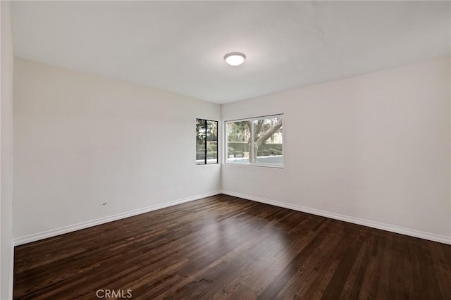 empty room featuring dark hardwood / wood-style flooring