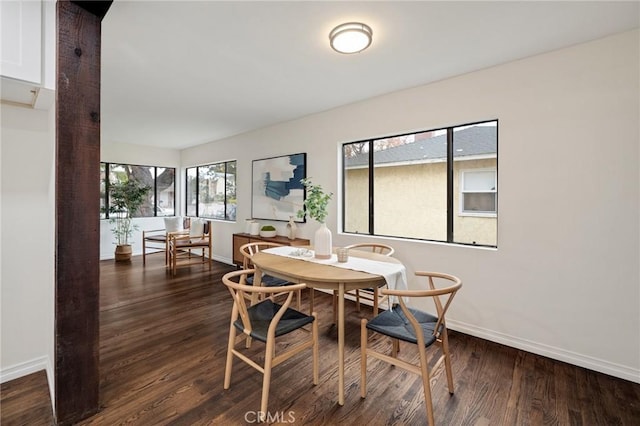 dining space with dark wood-type flooring