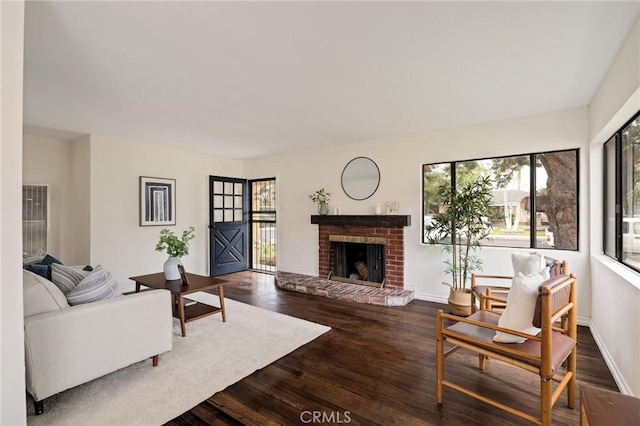 living room featuring a fireplace and dark hardwood / wood-style floors