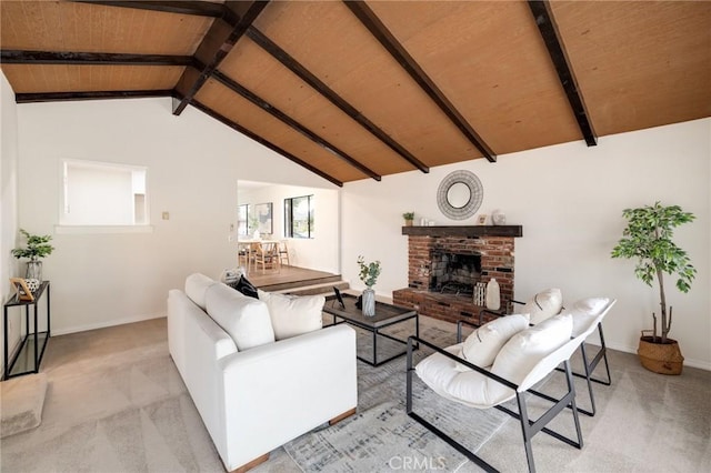 carpeted living room featuring a fireplace, lofted ceiling with beams, and wooden ceiling