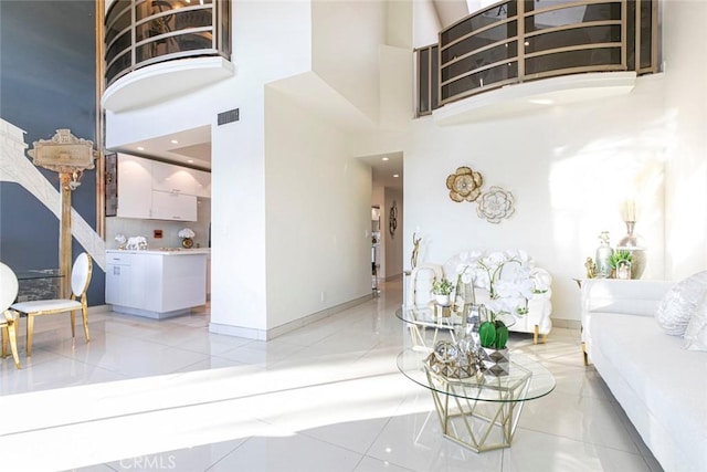 interior space with tile patterned flooring and a high ceiling