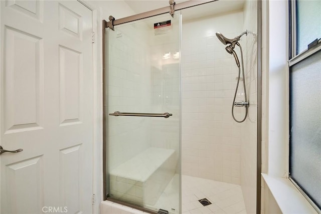 bathroom featuring a shower with shower door