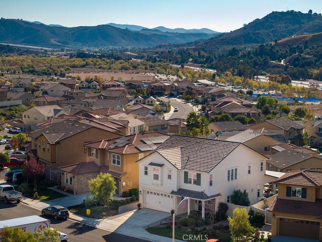 birds eye view of property with a mountain view