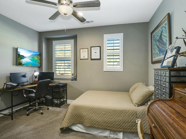 carpeted bedroom with multiple windows and ceiling fan