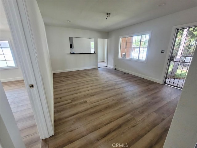 unfurnished room with hardwood / wood-style floors