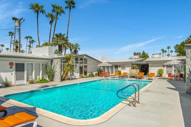 view of swimming pool featuring a patio area