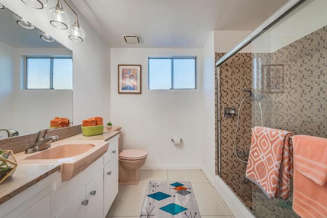 bathroom with vanity, tile patterned floors, an enclosed shower, and a healthy amount of sunlight