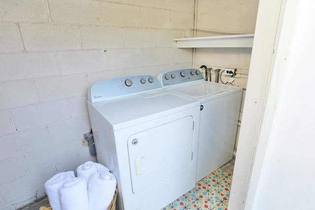 clothes washing area featuring washing machine and clothes dryer