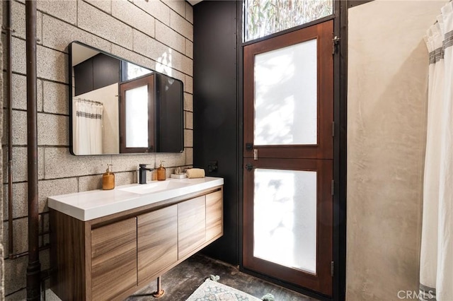 bathroom with vanity and concrete flooring