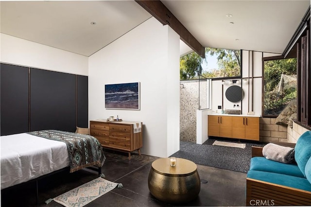 bedroom featuring vaulted ceiling with beams