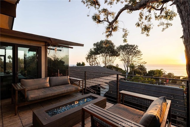 deck at dusk with a fire pit