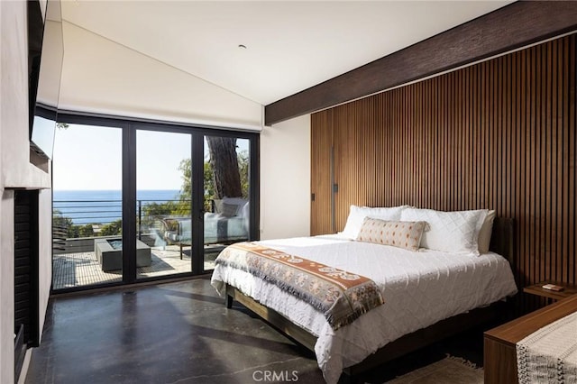 bedroom featuring access to outside and a water view