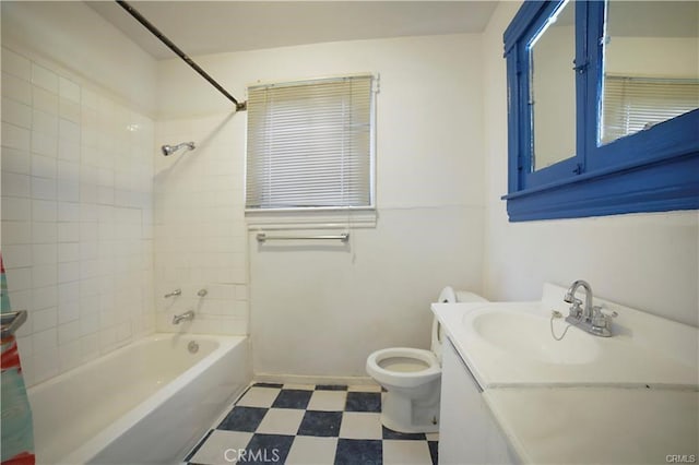 full bathroom with vanity, tiled shower / bath, and toilet