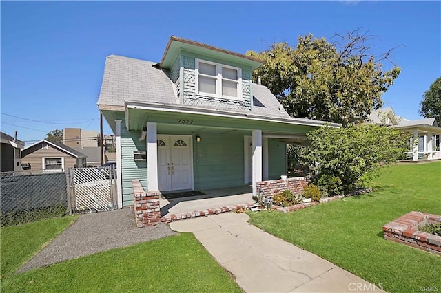 view of front facade with a porch and a front lawn