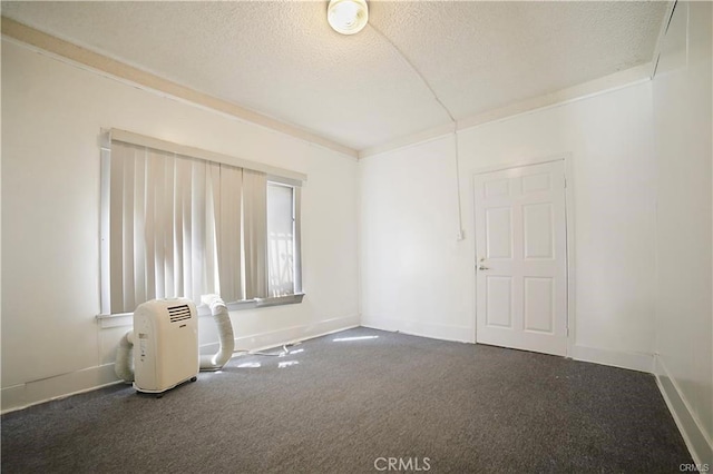 carpeted empty room with a textured ceiling