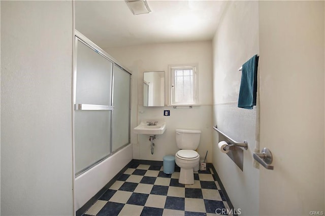 full bathroom featuring sink, toilet, and enclosed tub / shower combo