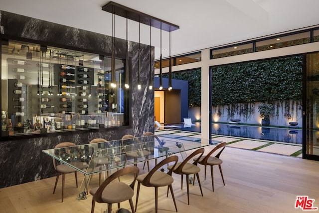 bar with hardwood / wood-style floors and expansive windows