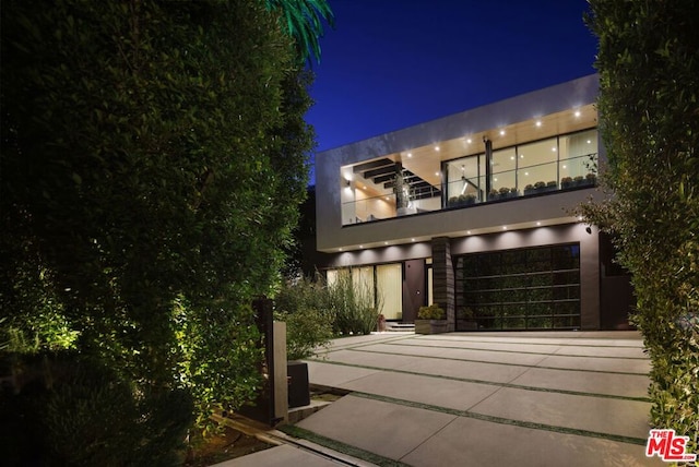 view of front of house featuring a balcony and a garage