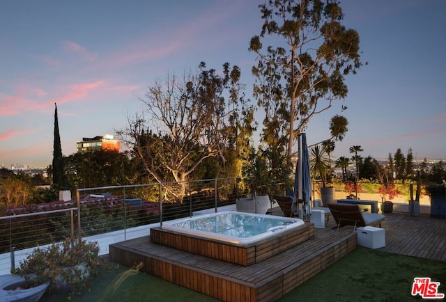 pool at dusk with a wooden deck