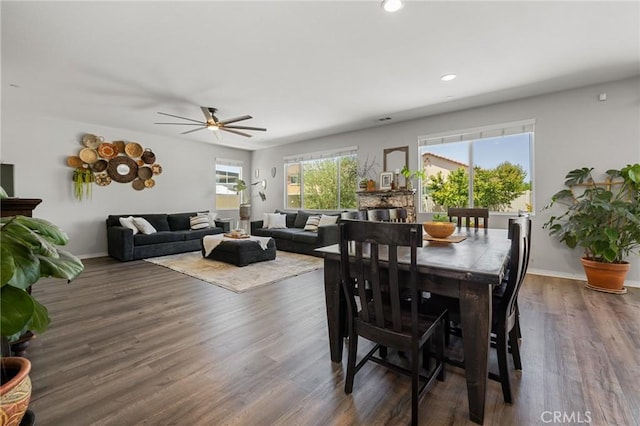 dining area featuring dark wood-type flooring and ceiling fan