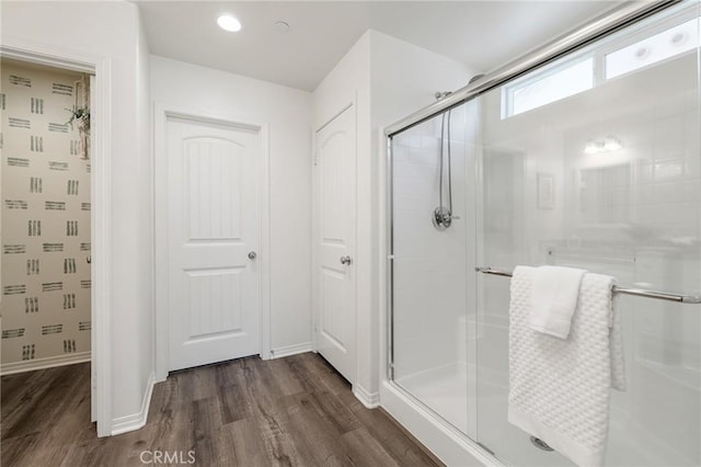 bathroom featuring wood-type flooring and walk in shower