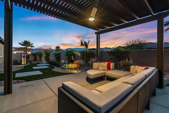 patio terrace at dusk featuring outdoor lounge area and a pergola